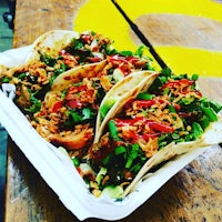 a tray of tacos on a wooden table