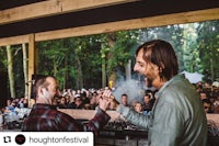 a man is shaking hands with another man at a festival