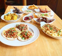 a wooden table with plates of food on it