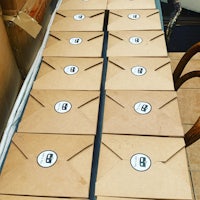 a bunch of brown envelopes lined up on a table