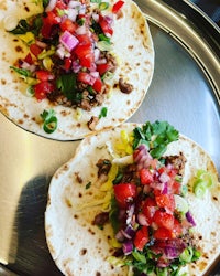 two tacos on a metal tray